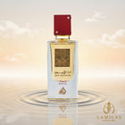 Ana Abiyedh Rouge perfume bottle with a golden scent and red cap, centered on rippling water under a soft, golden-toned sky.