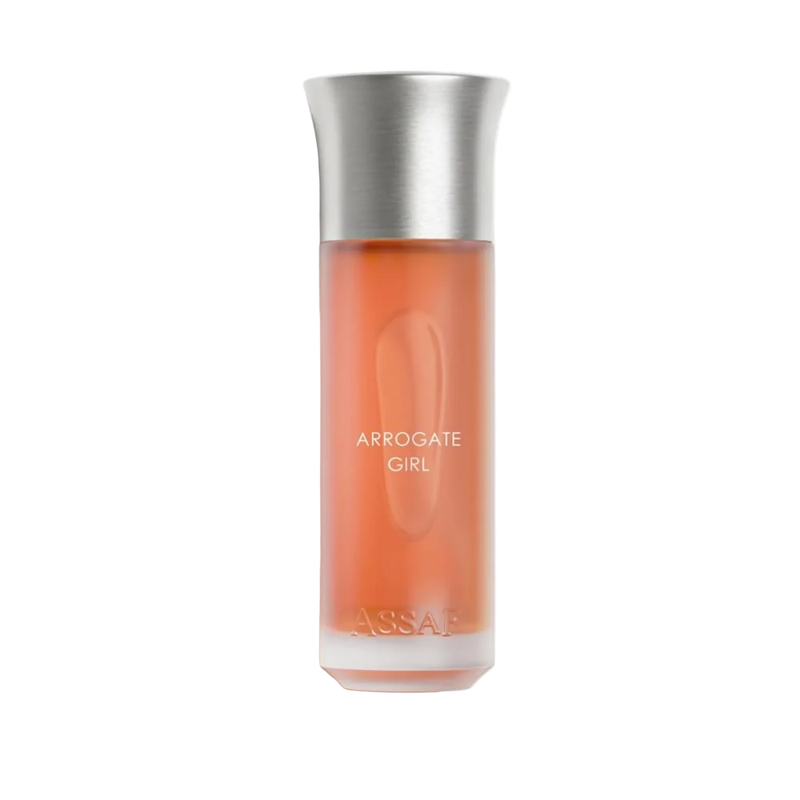 Assaf Arrogate Girl perfume bottle with a frosted orange-coral body, oval embossed detail, and a brushed silver cap.