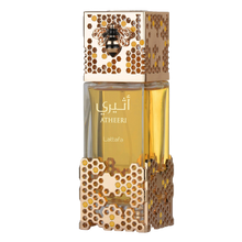 Golden perfume bottle with honeycomb-patterned casing, bee emblem cap, and Atheeri Lattafa branding.
