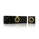 The image shows a sleek, rectangular black box with a glossy finish from the Master Perfumer Collection by Nabeel Perfumes. The box features elegant gold accents in the form of X and plus sign patterns across it. On the front, there's a round gold label with "Bakhoor Irth" inscribed within a circular frame showcasing silhouette imagery of Arabian desert scenes, including palm trees and camels.