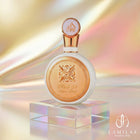 Circular white Fakhar Lattafa perfume bottle with gold detailing and an ornate emblem, set against a shimmering gold background.