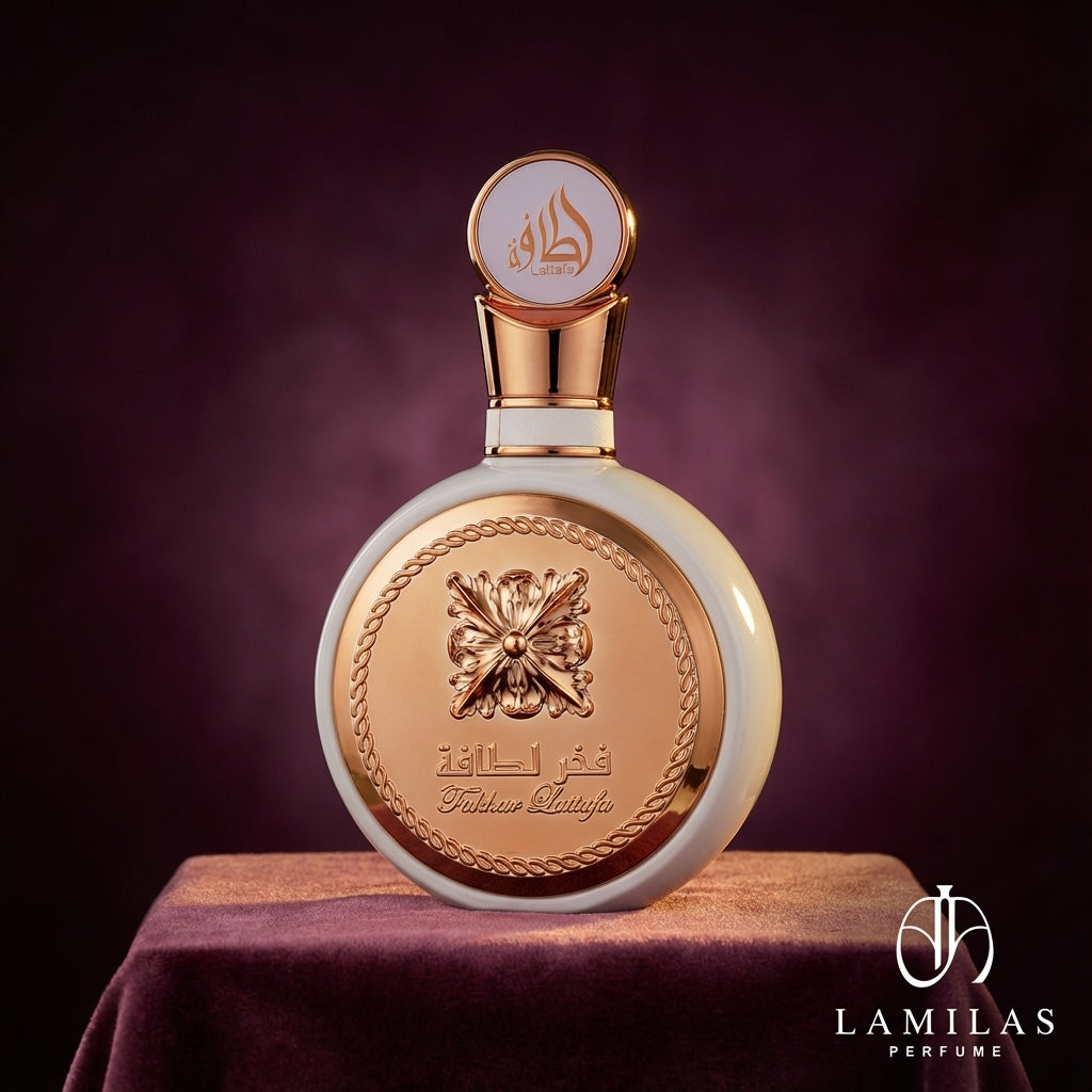 Elegant Fakhar Lattafa perfume bottle, white and gold, featuring an ornate metal plate, displayed on draped purple velvet.