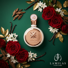 Fakhar Lattafa perfume bottle, white and rose gold, surrounded by red roses, vanilla, jasmine, and oud on a green background.