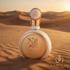 Fakhar Lattafa Women's white and gold perfume bottle showcased in a sunlit desert landscape.