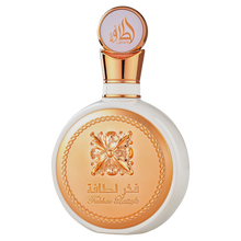 Elegant Fakhar Lattafa perfume bottle, white with a rose gold metallic cap and ornate golden relief detailing on the front.