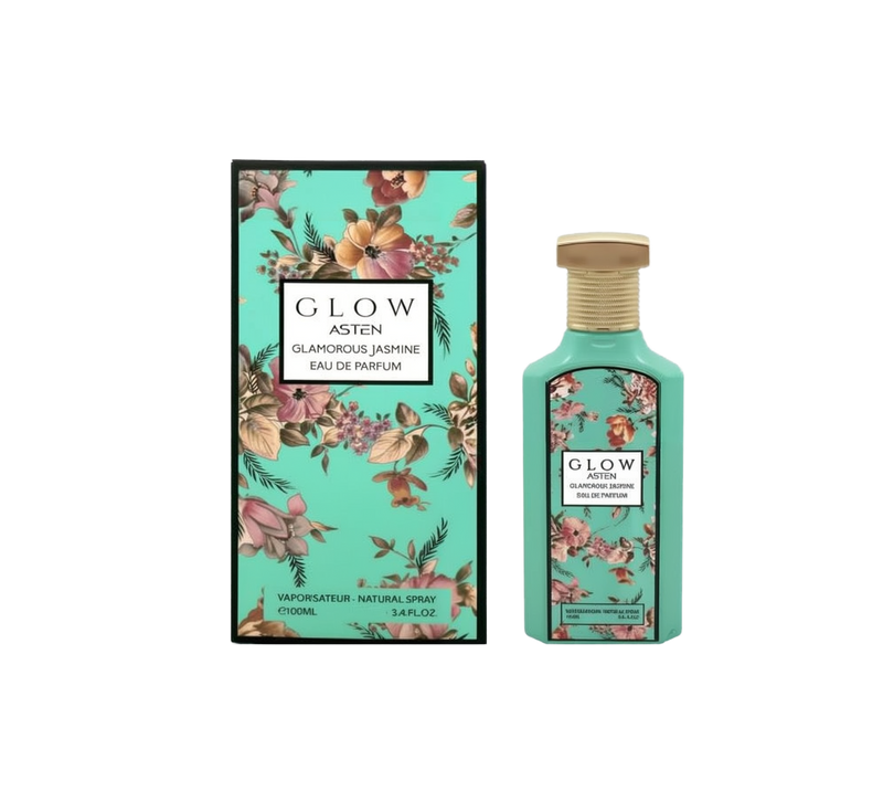 A tall, turquoise rectangular perfume bottle labeled “Glow Asten Glamorous Jasmine Eau De Parfum,” featuring a textured gold cap and a floral motif on the front. It is displayed alongside a matching turquoise box adorned with pink and brown flowers and the same product branding.