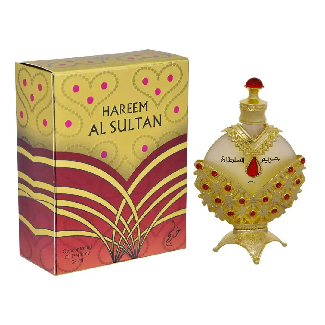 The image shows a richly decorated perfume box alongside a perfume bottle. The box has "HAREEM AL SULTAN" printed in bold, capital letters on a yellow and red patterned background, featuring heart and dot motifs, and a floral design
