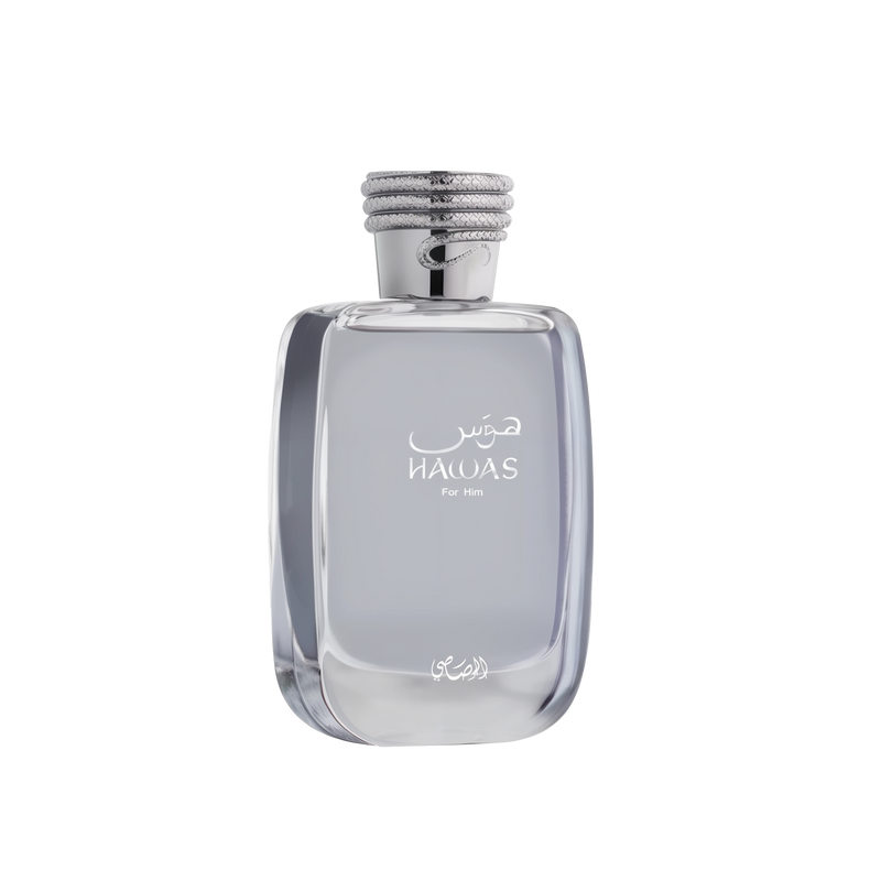 A close-up of the HAWAS For Him perfume bottle by Al Rasasi. It's a clear, rectangular glass bottle with rounded edges, filled with a light blue tinted liquid. The bottle features elegant white Arabic and English lettering that reads "HAWAS For Him." The cap is a textured silver, resembling a coiled rope design, which adds a sophisticated touch. The base of the bottle also has a delicate, white Arabic script logo.