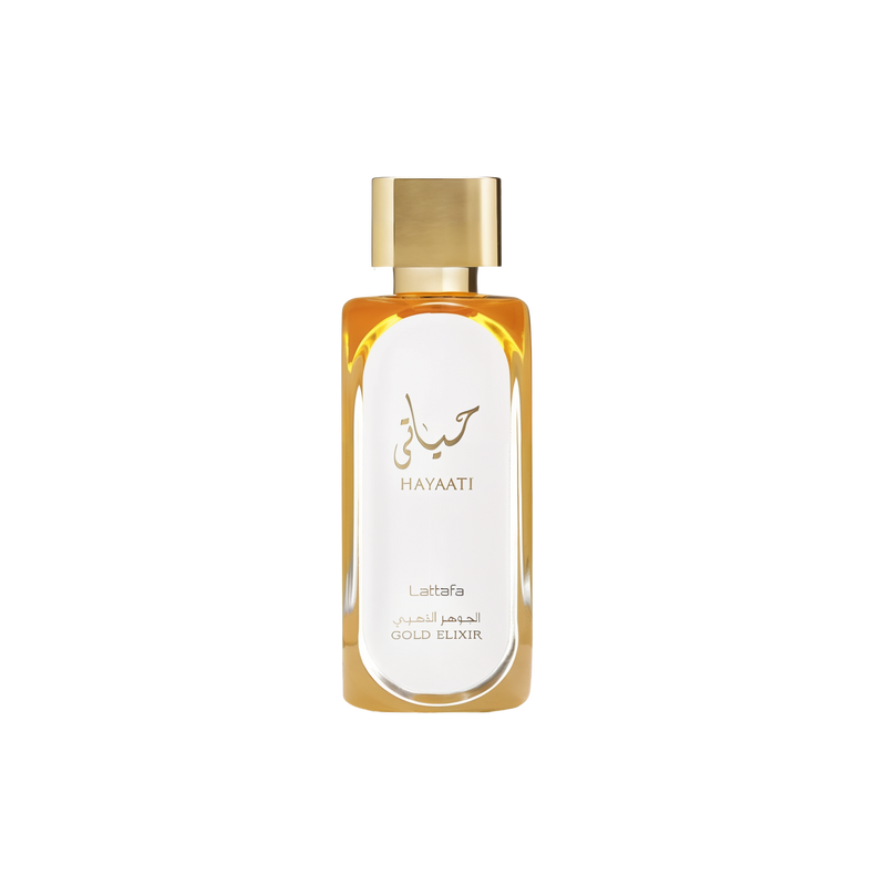 A rectangular glass perfume bottle filled with golden liquid, featuring a sleek gold cap. The front is printed with Arabic and English text reading “Hayaati Lattafa Gold Elixir.”