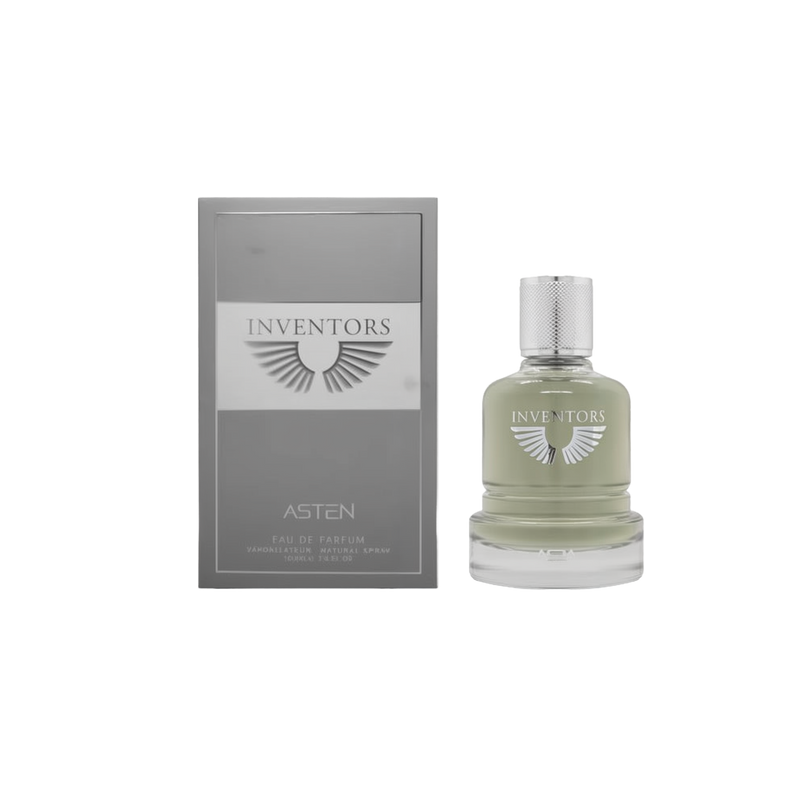 A round glass perfume bottle containing a pale green fragrance, topped with a textured silver cap and labeled ‘Inventors Asten,’ shown beside a grey rectangular box featuring the same winged logo and product name.