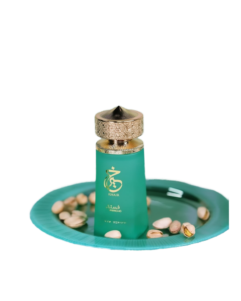 A perfume bottle labeled "Khair Pistachio" from Paris Corner. The bottle is an elegant, opaque mint-green color with gold accents, featuring a textured gold cap with a conical shape.