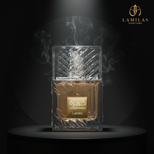 Lattafa Khamrah perfume bottle featuring etched glass and a textured cap, highlighted by spotlights and smoke.lattafa-khamrah-eau-de-parfum-textured-bottle-black-background.jpg