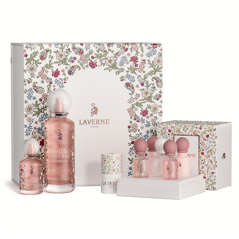 Miss Laverne Garden collection featuring pink perfume bottles, minis, and floral gift boxes arranged.