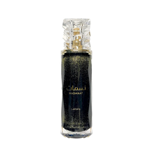 Lattafa Nasmaat perfume bottle in black with gold shimmer and a faceted clear cap.