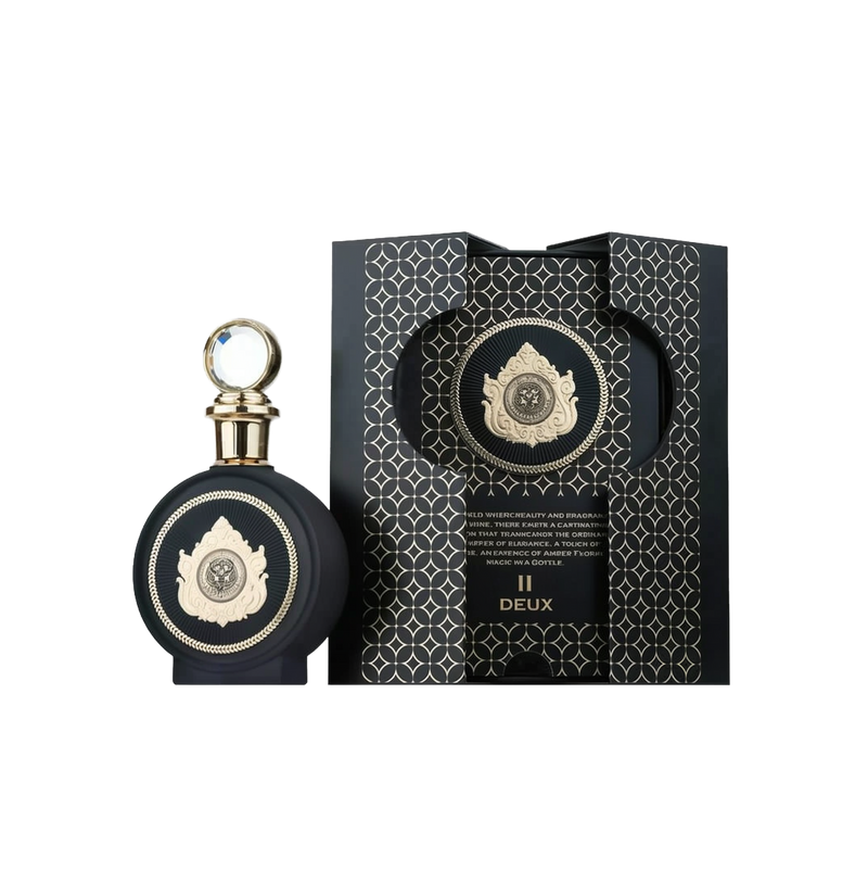 A sophisticated perfume bottle labeled "II Deux" by North Stag, a Paris Corner product. The bottle is round with a matte black finish and features an intricate gold emblem at the center, showcasing an ornate design with a medallion motif. The cap is gold 