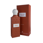 A sophisticated bottle of Nude Coral Diamond Eau e Parfum by Ibraheem Al-Qurashi, displayed next to its matching box. The bottle features a matte, coral-colored geometric texture with a diamond pattern and a white rectangular label that reads 'NUDE CORAL DIAMOND' in red text. It is topped with a smooth, rounded white cap. The packaging mirrors the coral color and minimalist aesthetic, with the same label and white brand markings near the base.