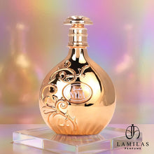 Arabiyat Nyla gold perfume bottle featuring intricate floral embossing, set against a shimmering pastel holographic background.