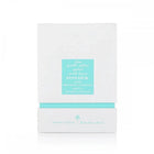 The image shows a white box with a teal label, which is likely the packaging for a fragrance or hair care product. The label features both English and Arabic text, reading "POWDER MUSK" and "IBRAHEEM AL QURASHI SPECIAL KHAMRIYA FOR HAIR." 