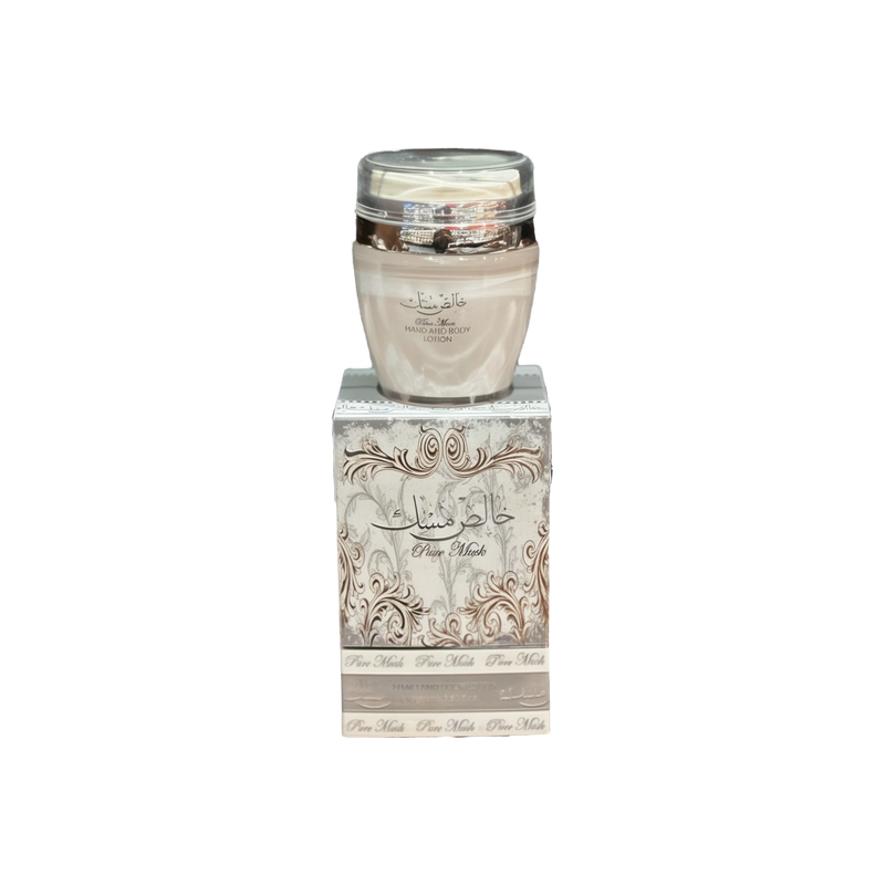 The image shows a product named "Pure Musk Hand and Body Lotion." The lotion is packaged in a light beige container with a clear lid and placed on top of a matching beige box adorned with intricate, elegant silver patterns and Arabic calligraphy. The box prominently features the product name "Pure Musk." The sophisticated packaging suggests a luxurious and high-quality skincare product.