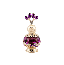 An elegant purple perfume bottle with a gold ornate cap featuring purple gemstones, displayed next to a luxurious purple box with gold floral patterns