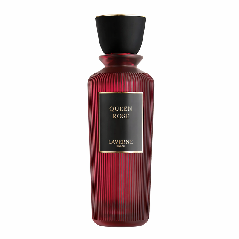 Red ribbed glass perfume bottle with black cap and gold label reading “Queen Rose”.