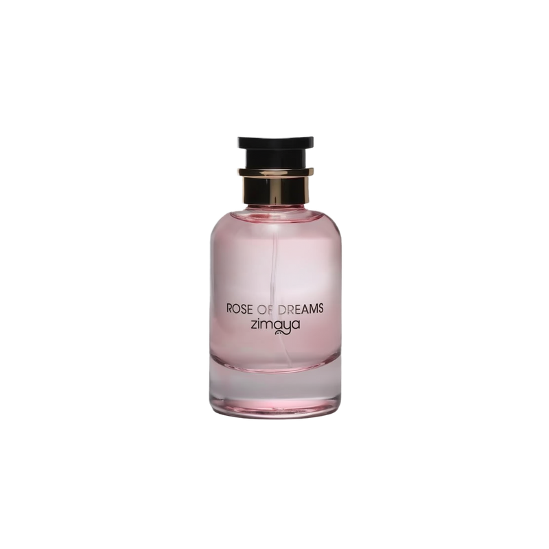 The image shows a bottle of "Rose of Dreams" eau de parfum by Zimaya. The perfume bottle is cylindrical with a soft pink hue and a clear glass bottom. It features a black cap with a gold band. The front of the bottle has black text that reads "ROSE OF DREAMS" and "zimaya." The overall design is elegant and minimalist, with the soft pink color evoking a sense of femininity and romance.