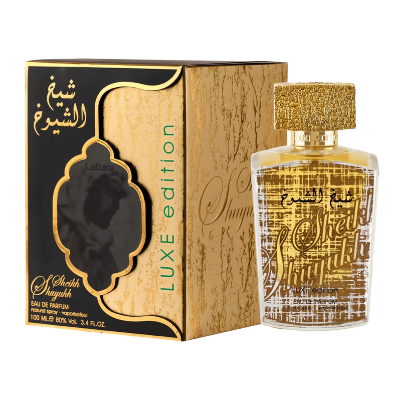 A boxed and unboxed view of Sheikh Al Shuyukh Luxe Edition by Lattafa Perfumes. The packaging features a gold and black design, with intricate detailing and Arabic calligraphy. The words "Luxe Edition" are displayed on the side of the box, and the front h