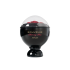 A glossy black, spherical perfume bottle labeled “Souvenir Blooming Bliss” by Afnan, topped with a transparent dome showcasing sculpted red roses underneath.