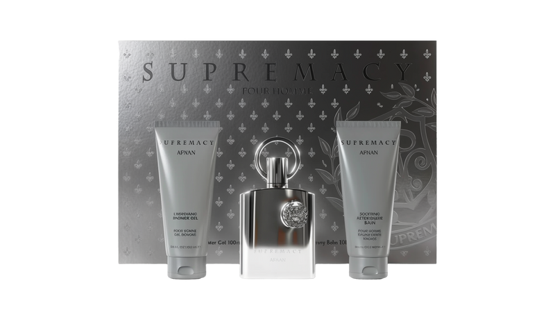 The Supremacy Silver gift set by Afnan Perfumes, featuring a silver perfume bottle with a circular handle, centered between two grey tubes. The tube on the left is the Energizing Shower Gel, and the one on the right is the Soothing After Shave Balm. 