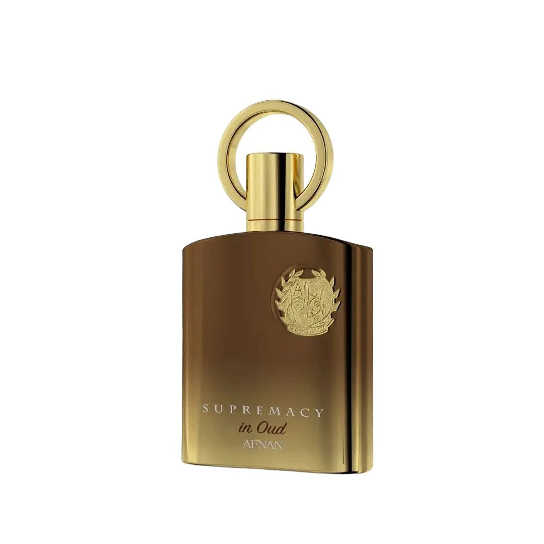  The image features an elegant and luxurious perfume bottle. The bottle is of a rich, brown color with a high shine finish, suggesting a glass or metallic material. It has a unique, gold-colored cap with a loop on top, resembling a ring or a handle, which adds a decorative and functional element to the design. A detailed, embossed emblem is prominently displayed in the center of the bottle, giving it a regal touch. Below the emblem, the words "SUPREMACY in Oud AFNAN" are printed in gold.