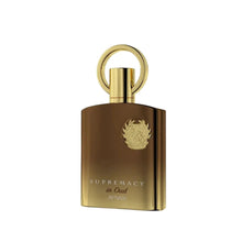  The image features an elegant and luxurious perfume bottle. The bottle is of a rich, brown color with a high shine finish, suggesting a glass or metallic material. It has a unique, gold-colored cap with a loop on top, resembling a ring or a handle, which adds a decorative and functional element to the design. A detailed, embossed emblem is prominently displayed in the center of the bottle, giving it a regal touch. Below the emblem, the words "SUPREMACY in Oud AFNAN" are printed in gold.
