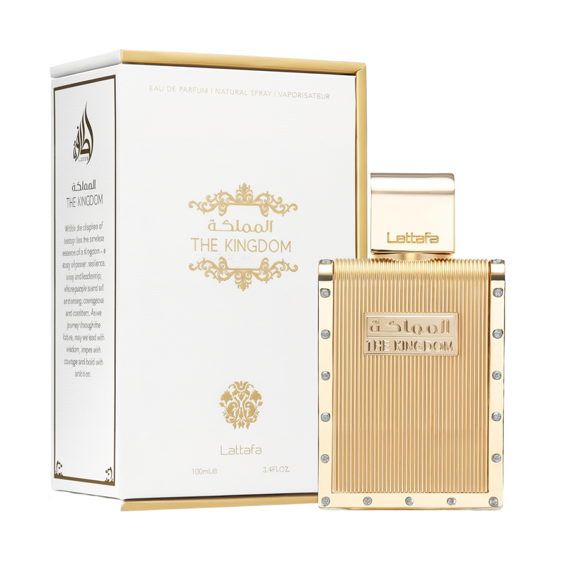 A rectangular gold perfume bottle, accented with vertical ridges and small round crystals along the edges, labeled “The Kingdom” in raised lettering. A matching gold cap features the Lattafa logo, and the bottle is displayed beside a white box embellished with gold flourishes, product details, and “THE KINGDOM” branding.